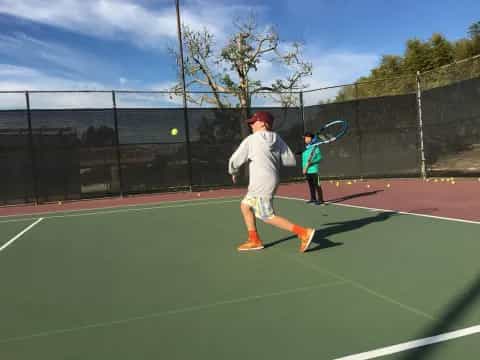 a boy playing tennis