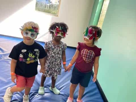 a group of children wearing masks