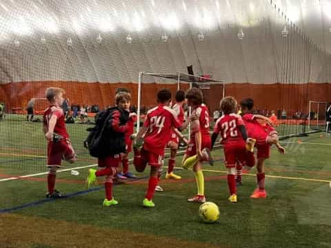 a group of kids playing football