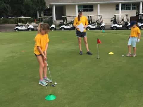 a group of people playing golf