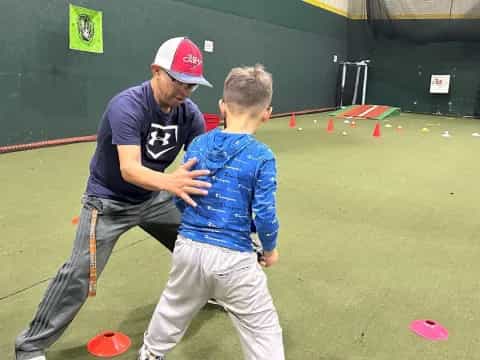 a man and a boy playing baseball