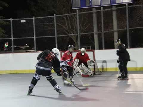 a group of people playing hockey