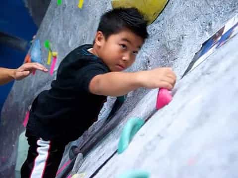 a boy climbing a slide