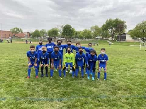 a group of kids in football uniforms