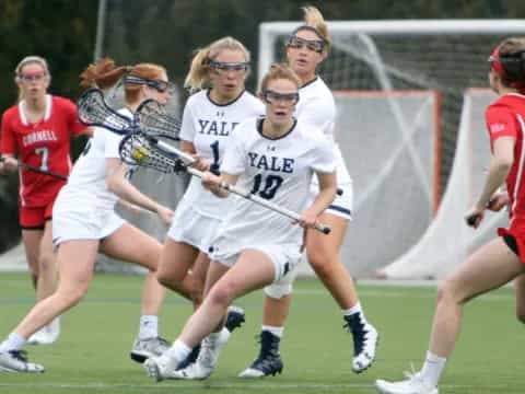 a group of women playing lacrosse