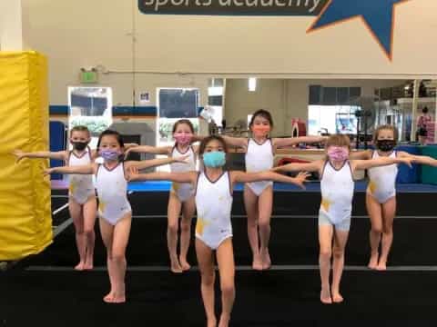 a group of girls in white dresses