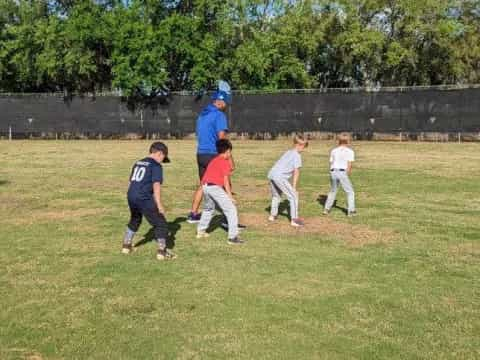 a group of kids playing baseball