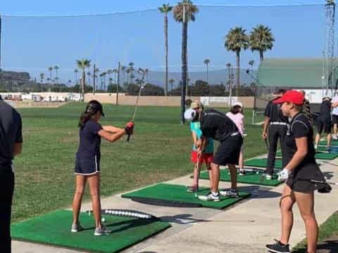 a group of people playing golf
