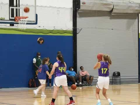 a group of girls playing basketball