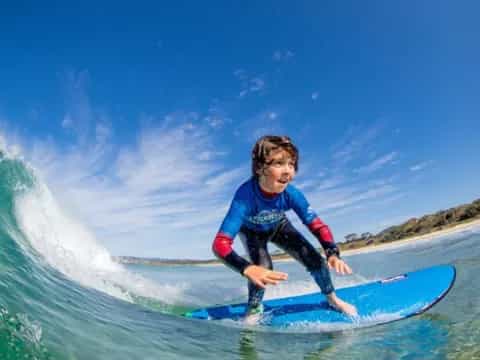 a boy riding a surfboard