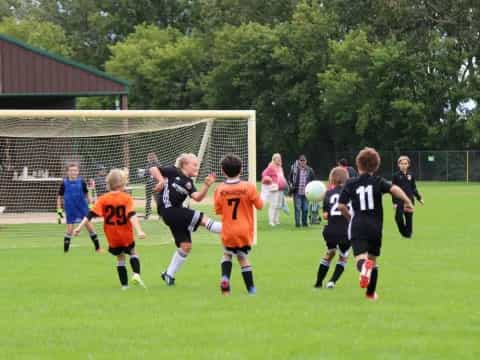 a group of kids playing football