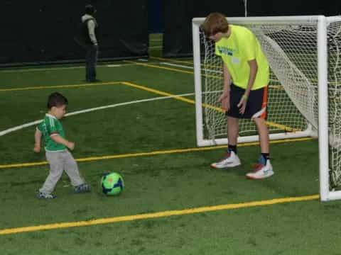 a person and a boy playing football