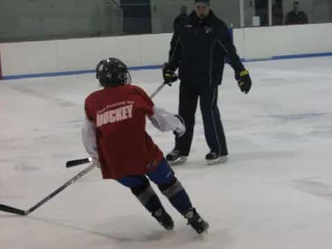 a man and a woman playing hockey