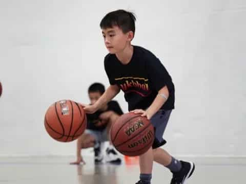 a boy holding a basketball