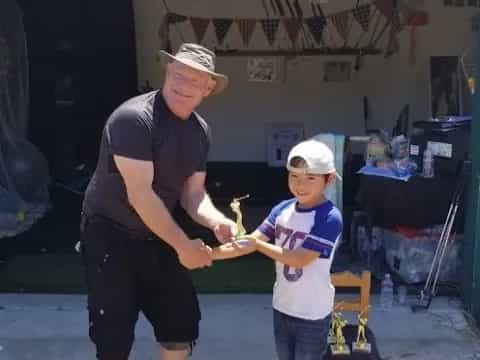 a man and a boy holding a small bird