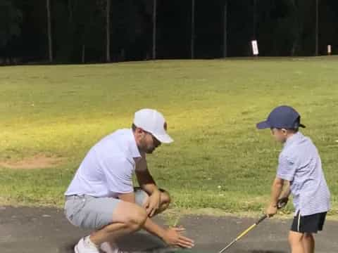 a man and a boy playing golf