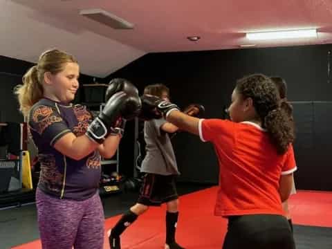 a group of girls in a boxing ring