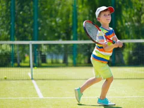 a boy playing tennis