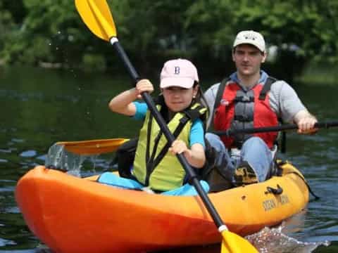 a person and a boy in a canoe