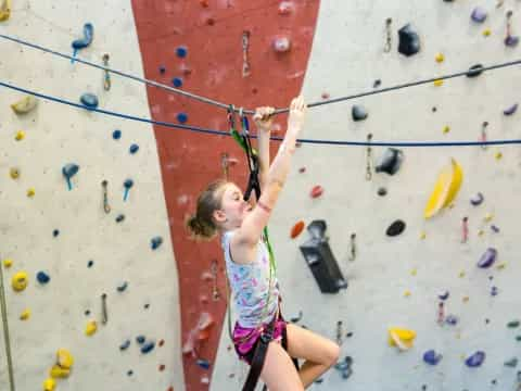 a girl climbing a rock wall