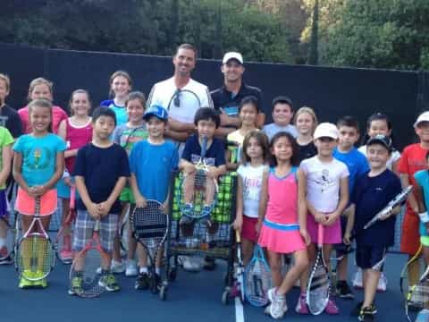 a group of people holding tennis rackets