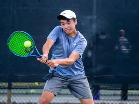 a man hitting a ball with a tennis racket