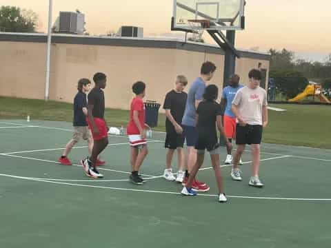 a group of people playing basketball