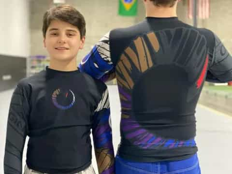 a couple of boys in hockey uniforms