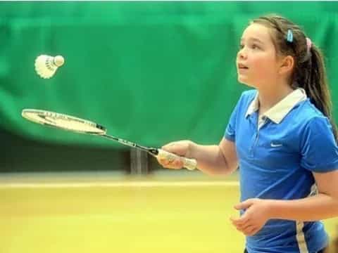 a girl swinging a tennis racket