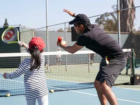 a man and a woman playing tennis