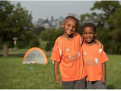 a group of boys in orange shirts