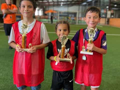 a group of boys holding trophies