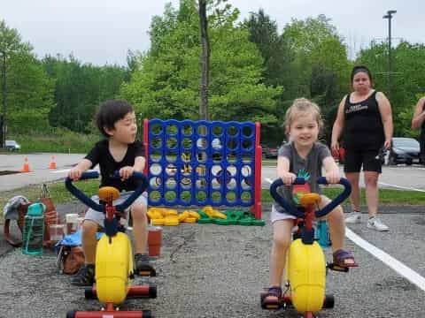 a group of kids on toy vehicles
