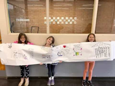 a group of girls holding a banner