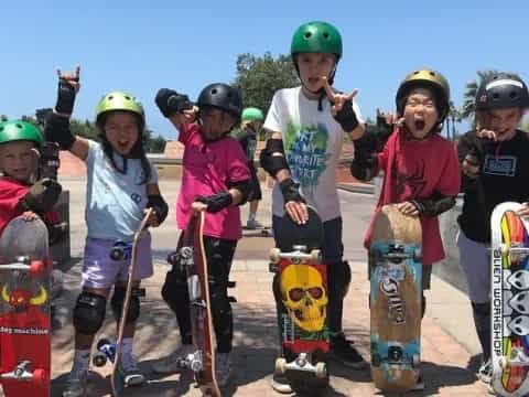 a group of kids holding skateboards