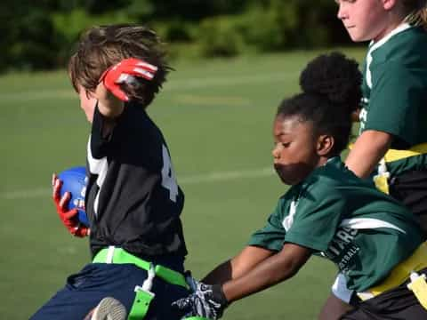 a group of kids playing football