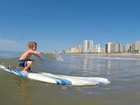 a boy riding a surfboard