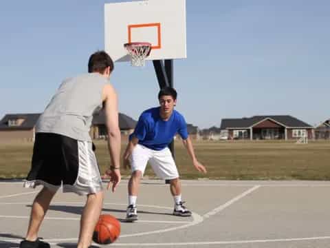 a man and a boy playing basketball
