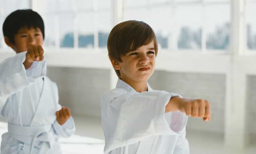 a couple of people in karate uniforms