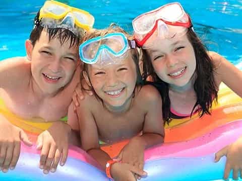 a group of kids in a pool