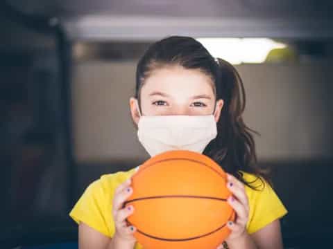 a girl holding a basketball