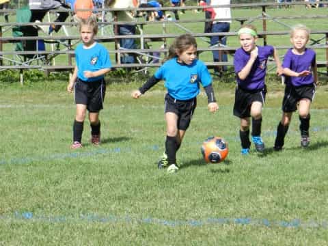 kids playing football on a field