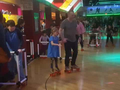 a person and a child in a bowling alley