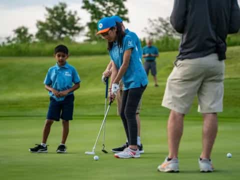a person and a boy playing golf