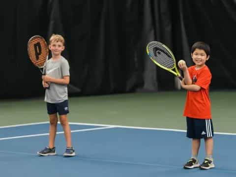kids holding tennis rackets