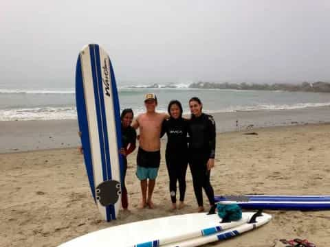 a group of people pose for a photo on a beach