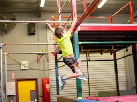 a man jumping on a bar