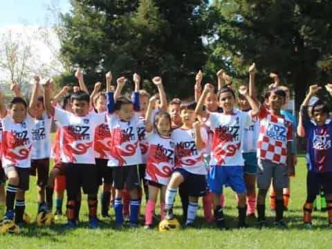 a group of kids in football uniforms