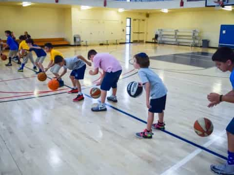 a group of kids playing basketball