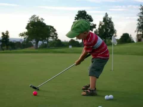 a boy playing golf